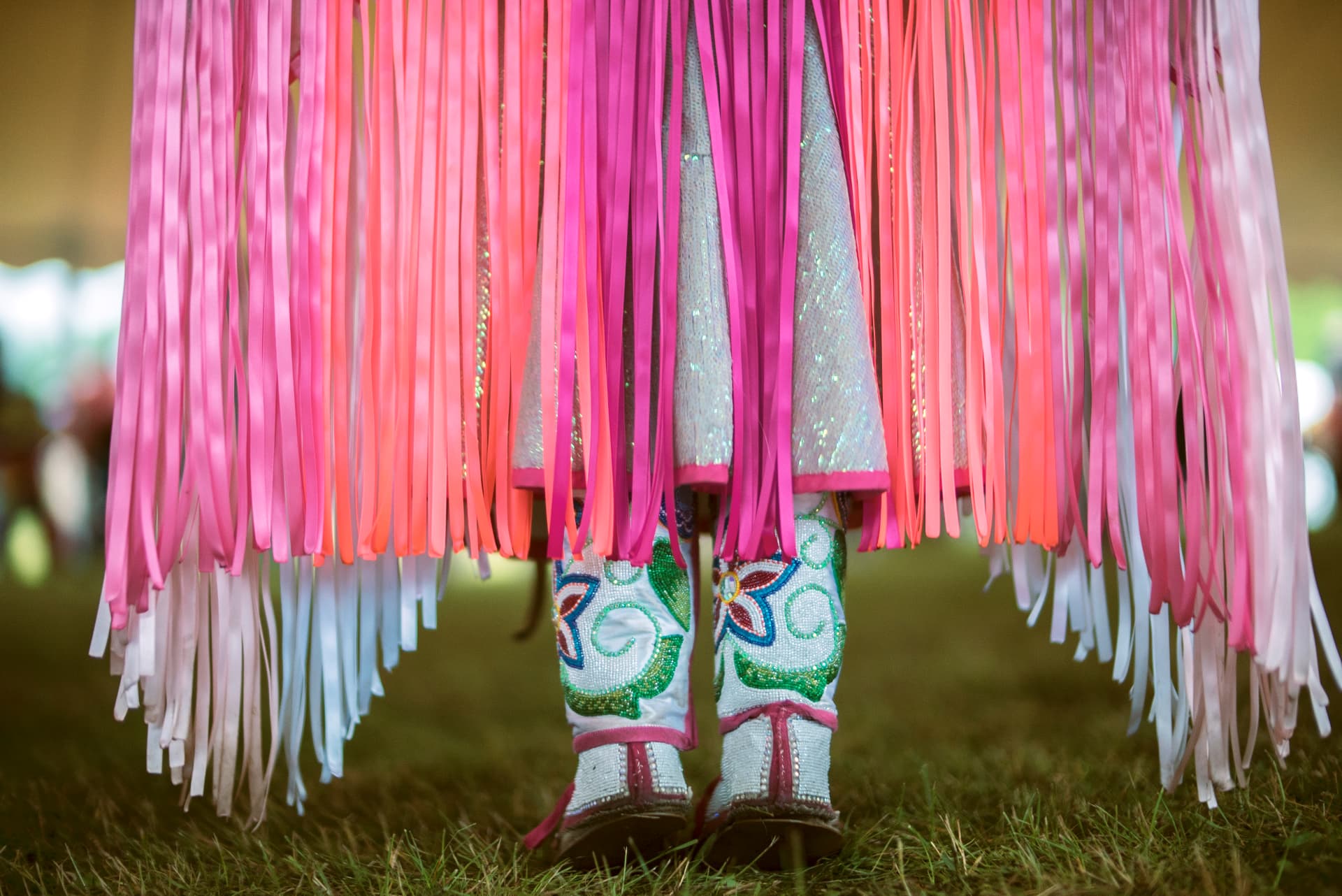 Pink ribbon fringe and beaded moccasins of a dancer